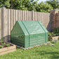 Green mini greenhouse cover over galvanized raised garden bed in outdoor yard