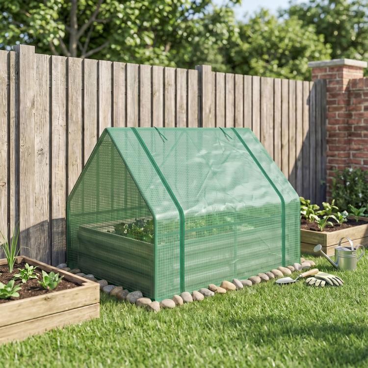 Green mini greenhouse cover over galvanized raised garden bed in outdoor yard
