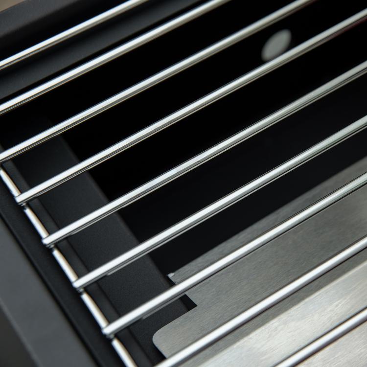 Tabletop gas grill grate with silver parallel bars and black frame