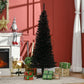 Black pencil artificial Christmas tree standing beside wrapped gifts