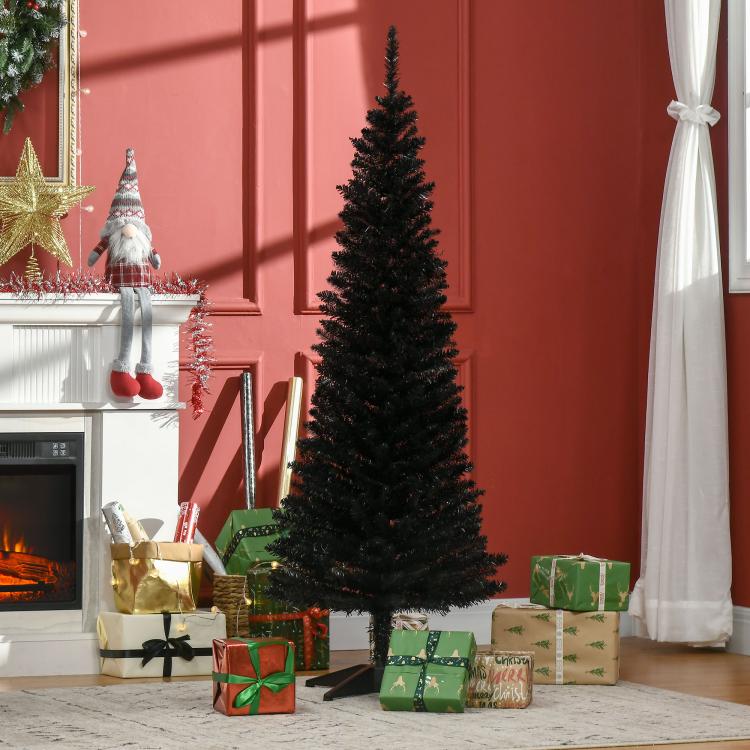 Black pencil artificial Christmas tree standing beside wrapped gifts