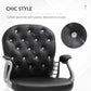 Black tufted backrest with crystal button accents, padded armrests, and chrome base