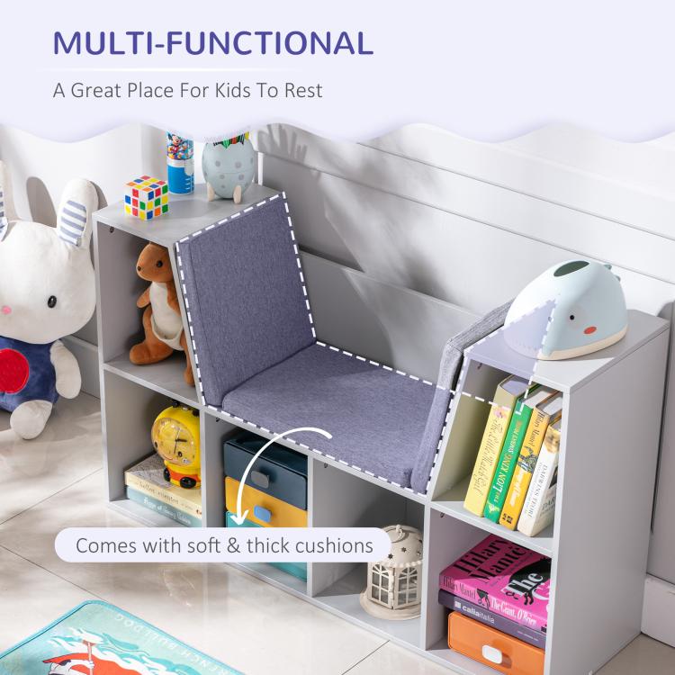 Kids bookcase with grey cushioned reading nook and cubbies holding books and toys
