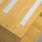 Close-up of natural wood pet stair top with cushioned white pads and screws