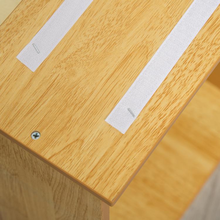 Close-up of natural wood pet stair top with cushioned white pads and screws