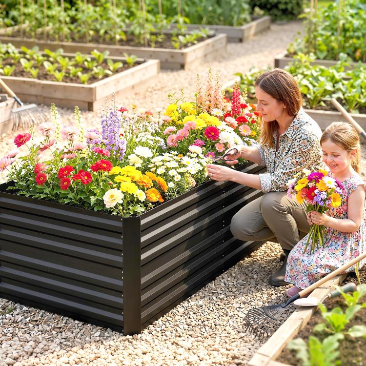 Black steel raised garden bed with flowering plants along the front edge