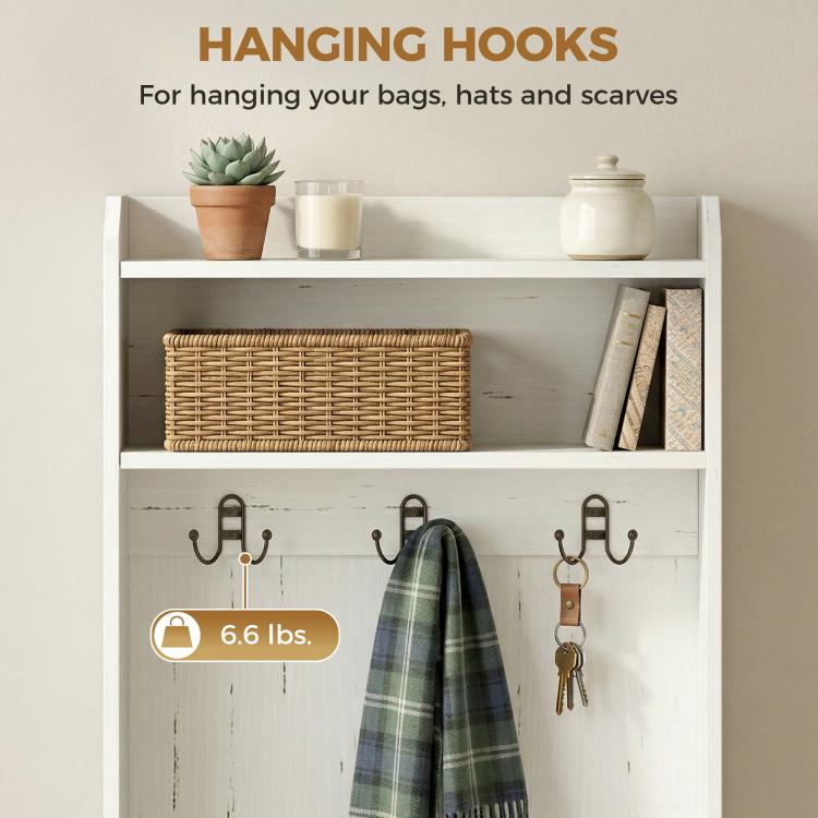White coat rack with multiple hanging hooks, shelves, and open shoe storage