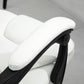 White high-back massage office chair armrest and side controls, padded upholstery