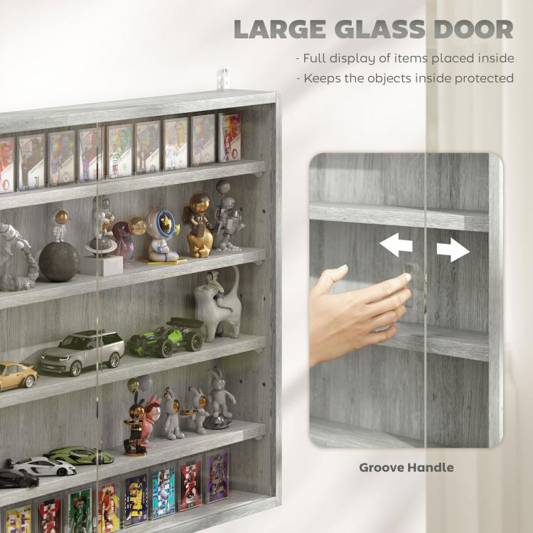 Gray display cabinet with large glass door and groove handle, shelves with collectibles inside.