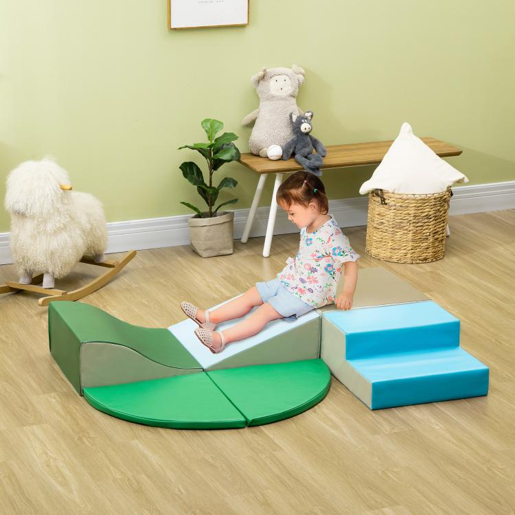 Toddler climbing on green and blue foam blocks with wedge steps