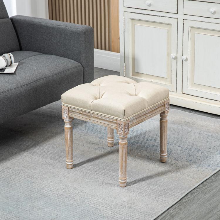 Beige ottoman bench footrest with tufted cushion and carved wooden legs