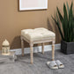 Beige ottoman bench with tufted top cushion and distressed carved wooden legs