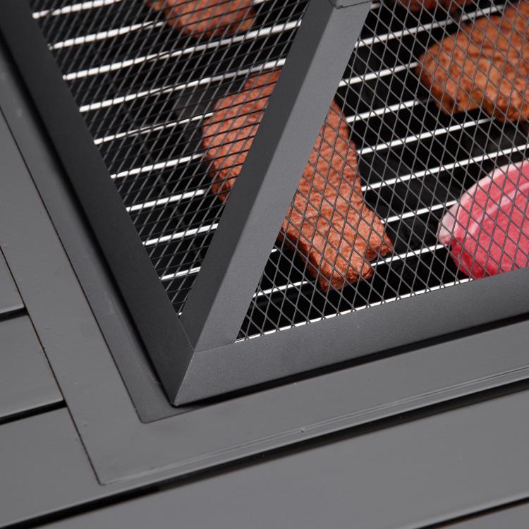 Black metal spark screen over fire pit grill with diamond mesh