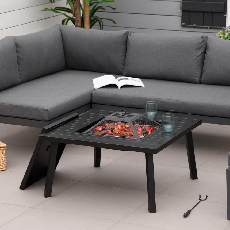 Black metal fire pit table with spark screen and flames in square bowl