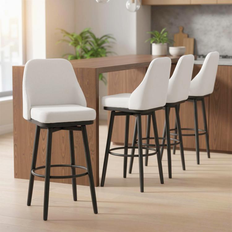 Set of 2 cream bar stools with padded seats, black legs, and circular footrests