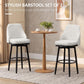Cream bar stools set of 2 with padded seat, arched backs, and black circular footrests