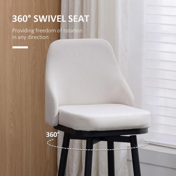 Cream bar stool with padded seat and rounded back, black circular footrest frame