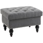 Gray button-tufted storage ottoman with removable lid, studded trim, and dark wood legs