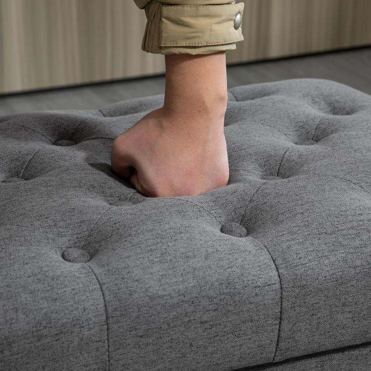 Gray tufted storage ottoman lid with rounded button pattern