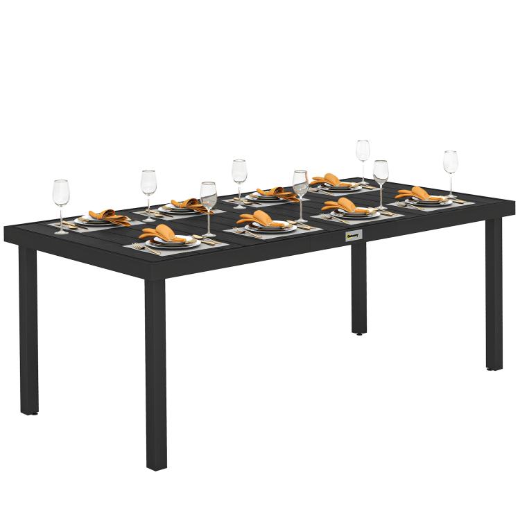 Rectangular outdoor dining table with black frame and faux wood slatted top