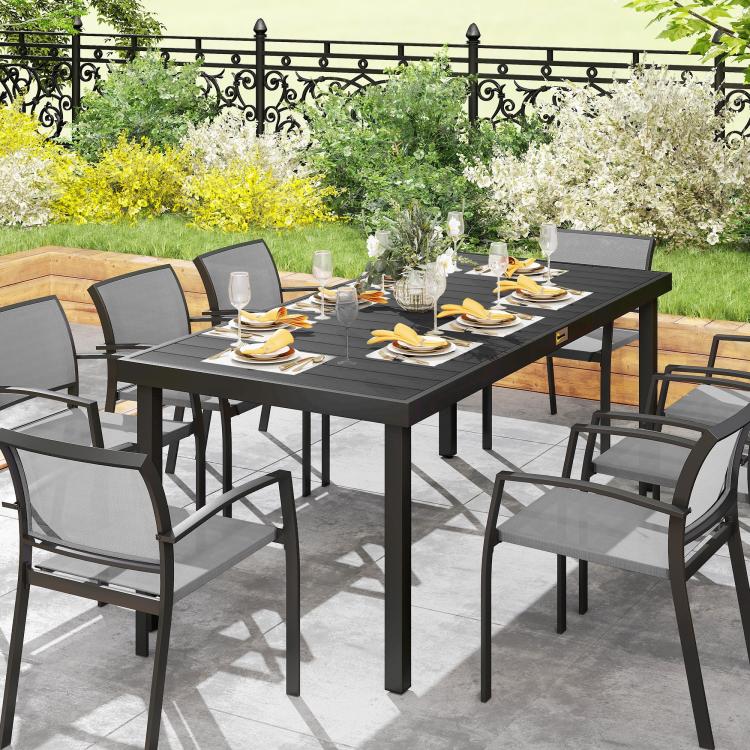Black rectangular outdoor dining table with faux-wood top and metal legs