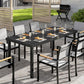 Outdoor dining table with black slatted tabletop and metal legs with chairs
