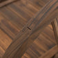 Stained wooden garden footbridge rail post with arched support joint detail