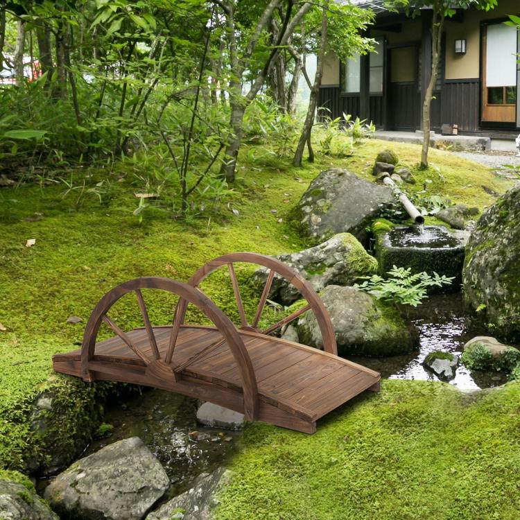 Stained wooden arched footbridge with wheel-style railings and slatted walking surface