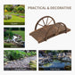 Stained wooden arched footbridge with wheel-style railings and slatted deck