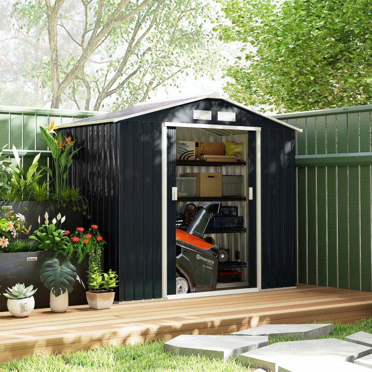 Dark gray outdoor storage shed with sliding doors, open front showing shelves and tools