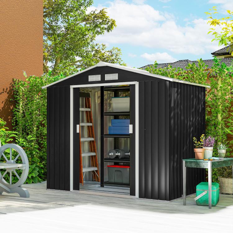 Dark gray outdoor storage shed with open sliding doors and shelving for gardening