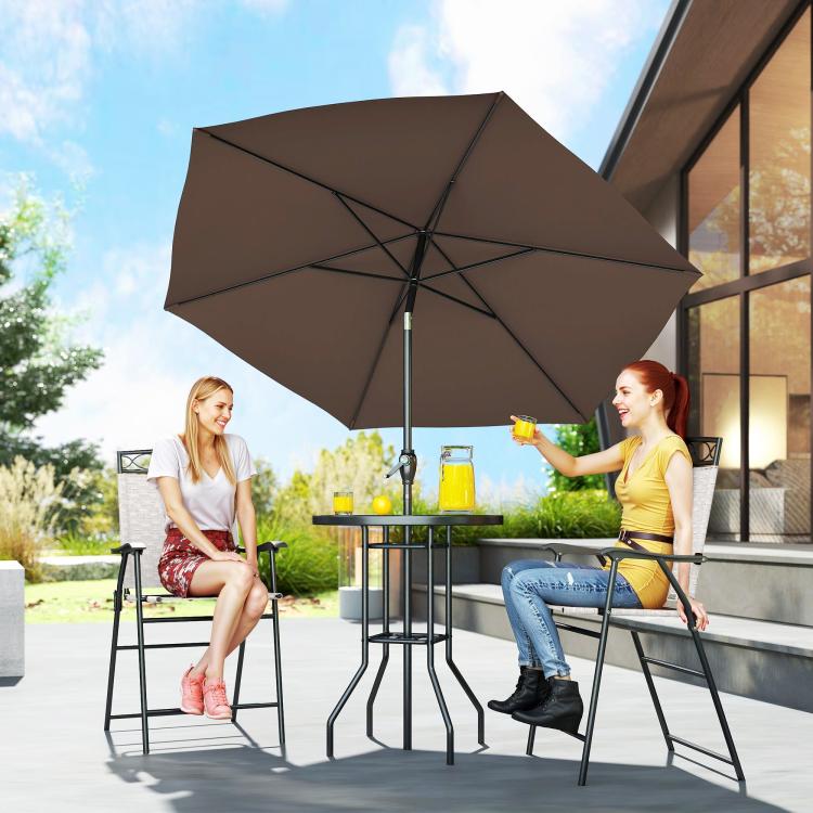 Outdoor patio bar set with brown umbrella and round table between two folding chairs