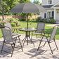Gray patio dining set with umbrella over round glass table and four folding mesh chairs