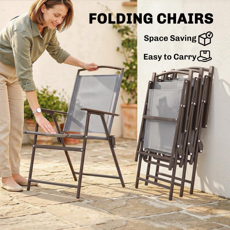 Gray folding patio chair with mesh back and seat, being carried