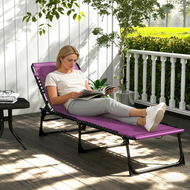 Purple folding chaise lounge chair with pillow; person reading while reclined
