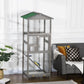 Grey outdoor bird cage aviary house with green roof, wire doors, and perch inside