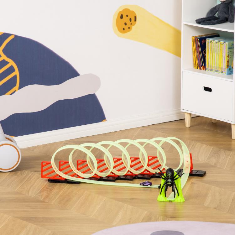 Glowing loop race track toy with pull-back car and green spider figure