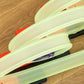 Close-up of glowing lime green track rails and loop section