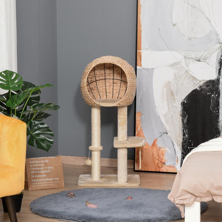 Beige cat tree with sisal condo and scratching posts, cat perched and rope hanging