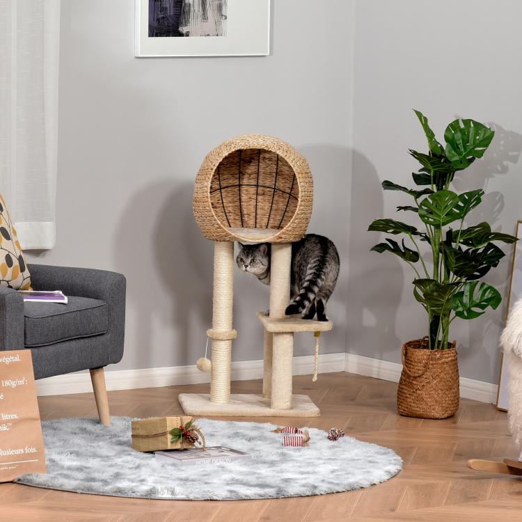 Beige cat tree with sisal condo and scratching posts, cat playing on platform and rope