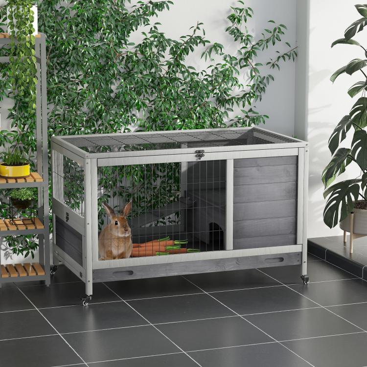 Elevated wooden hutch with wire front, gray solid wall panels, and lockable entry door