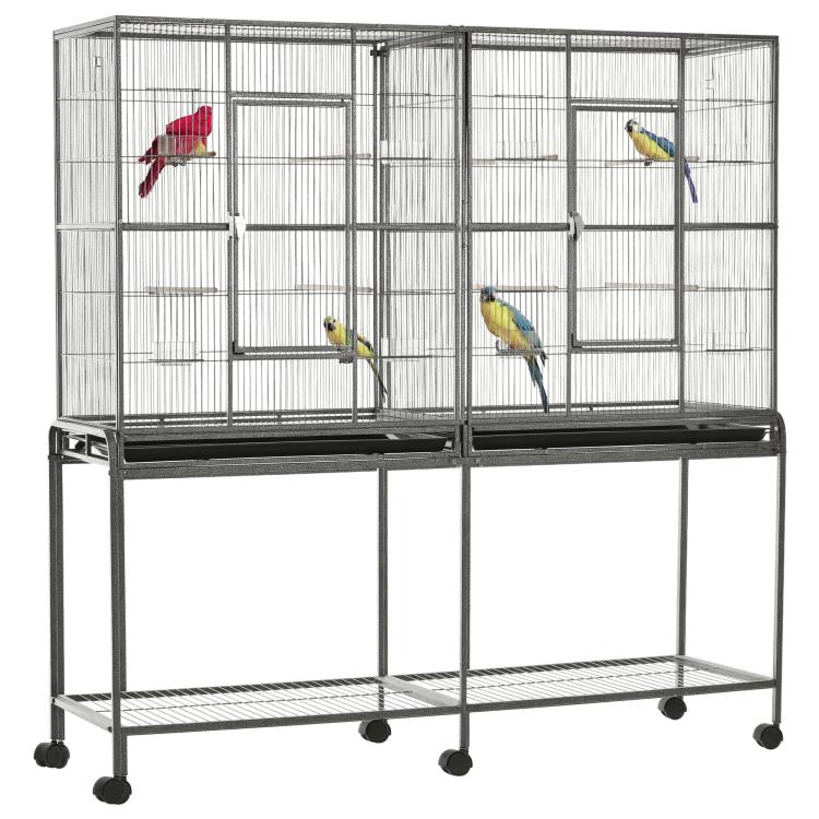 Bird cage with rolling base, wire enclosure and wooden perches, with colorful birds inside