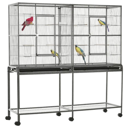 Bird cage with rolling base, wire enclosure and wooden perches, with colorful birds inside