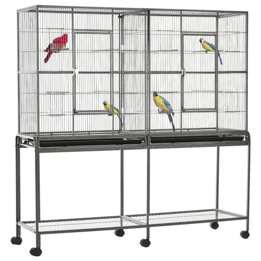 Bird cage with rolling base, wire enclosure and wooden perches, with colorful birds inside
