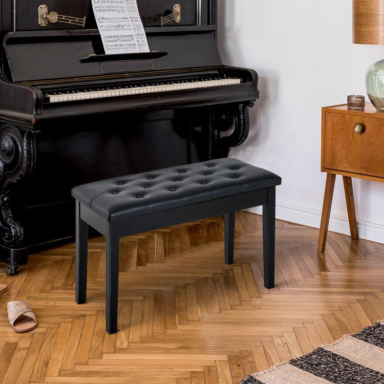 Black upholstered piano bench with tufted cushion and four wooden legs