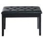 Black cushioned piano bench with tufted seat and four straight wooden legs