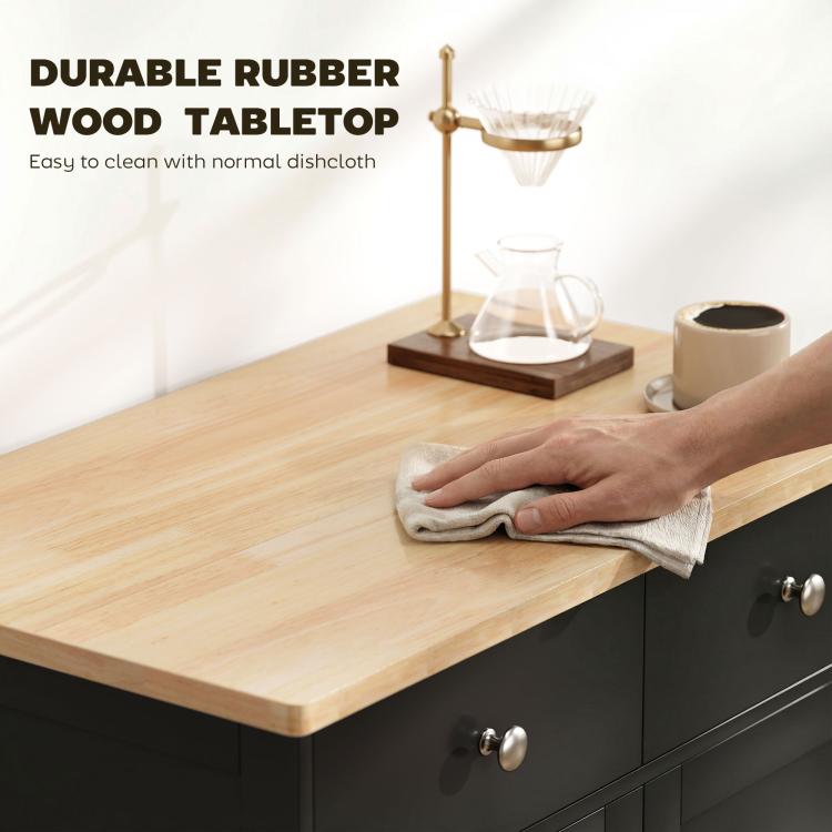 Black sideboard with light wood countertop and front drawers; hand wipes the surface
