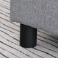 Gray linen footstool with black plastic cylindrical leg