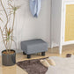 Gray upholstered cube ottoman foot stool with black plastic legs