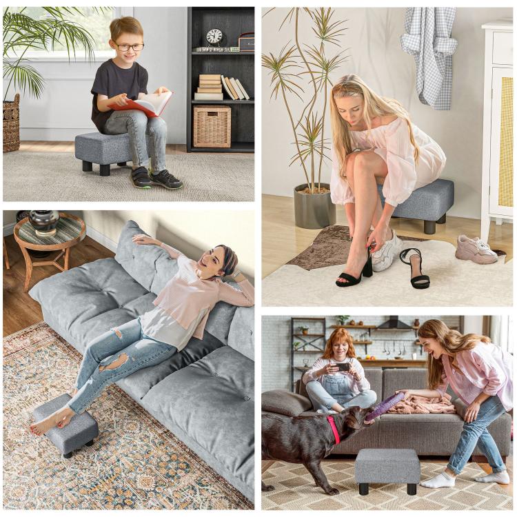 Gray cube ottoman foot rest shown in use, with fabric top and black legs